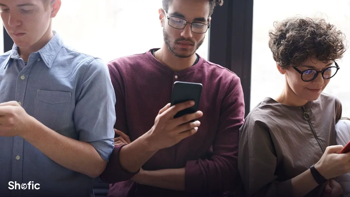 People using their phones at a café