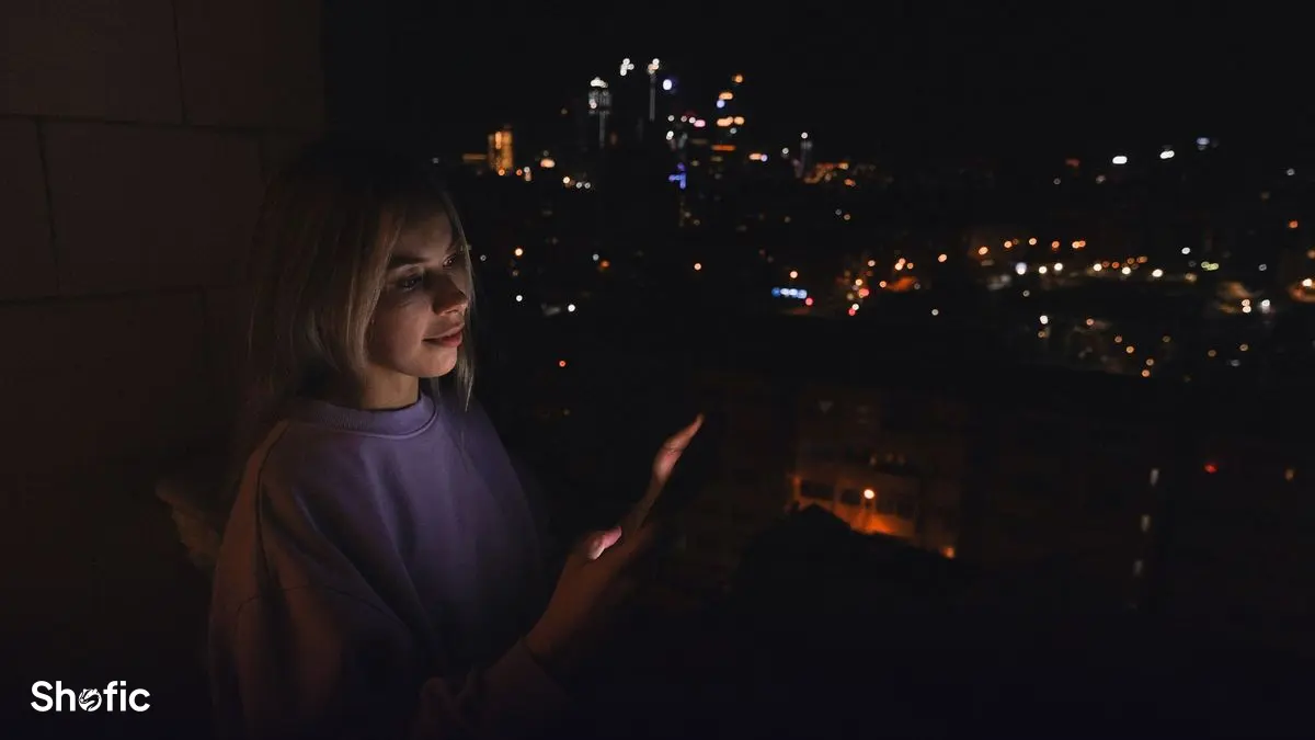 Someone using Snapchat on a phone outdoors in the evening