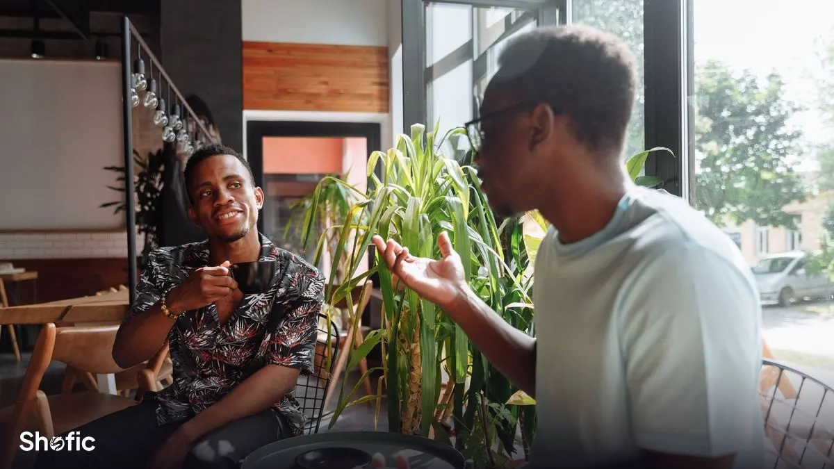 Friends at a café sharing something on their phones