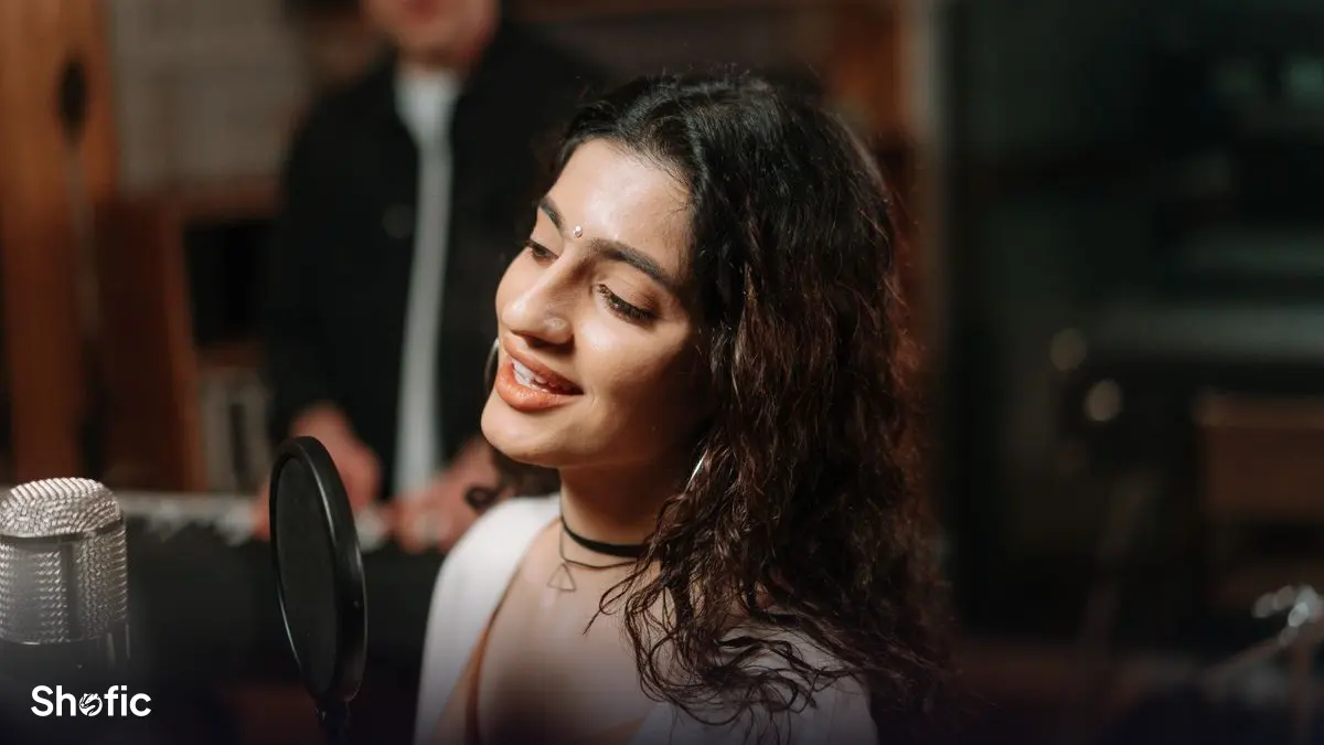 A singer recording vocals at a microphone