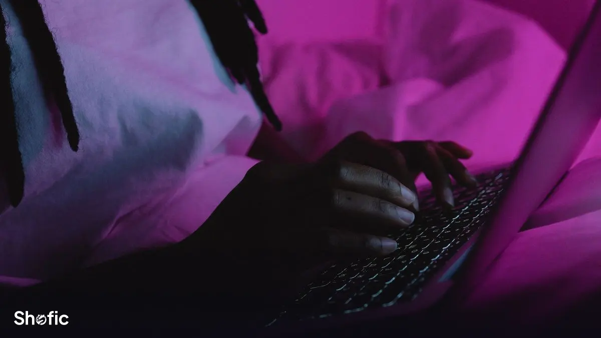 Someone writing a post on a laptop late at night