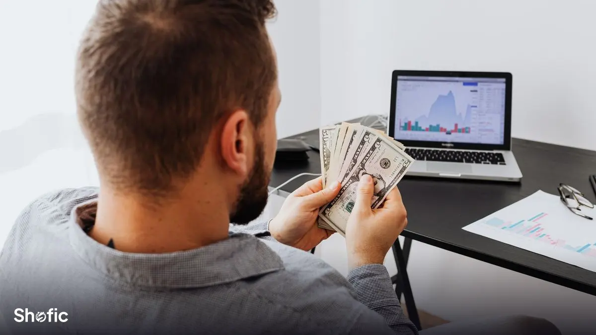 Reviewing channel earnings on a laptop at a desk